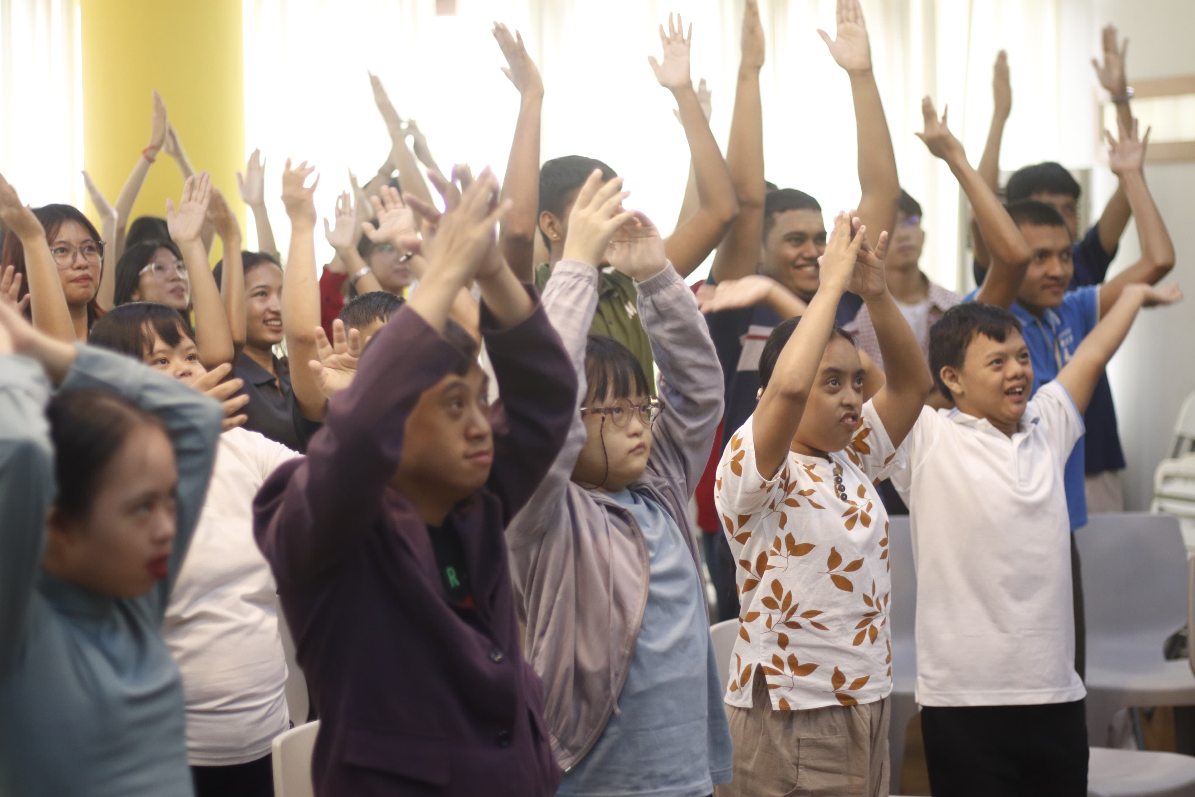 Workshop participants raising their hands together