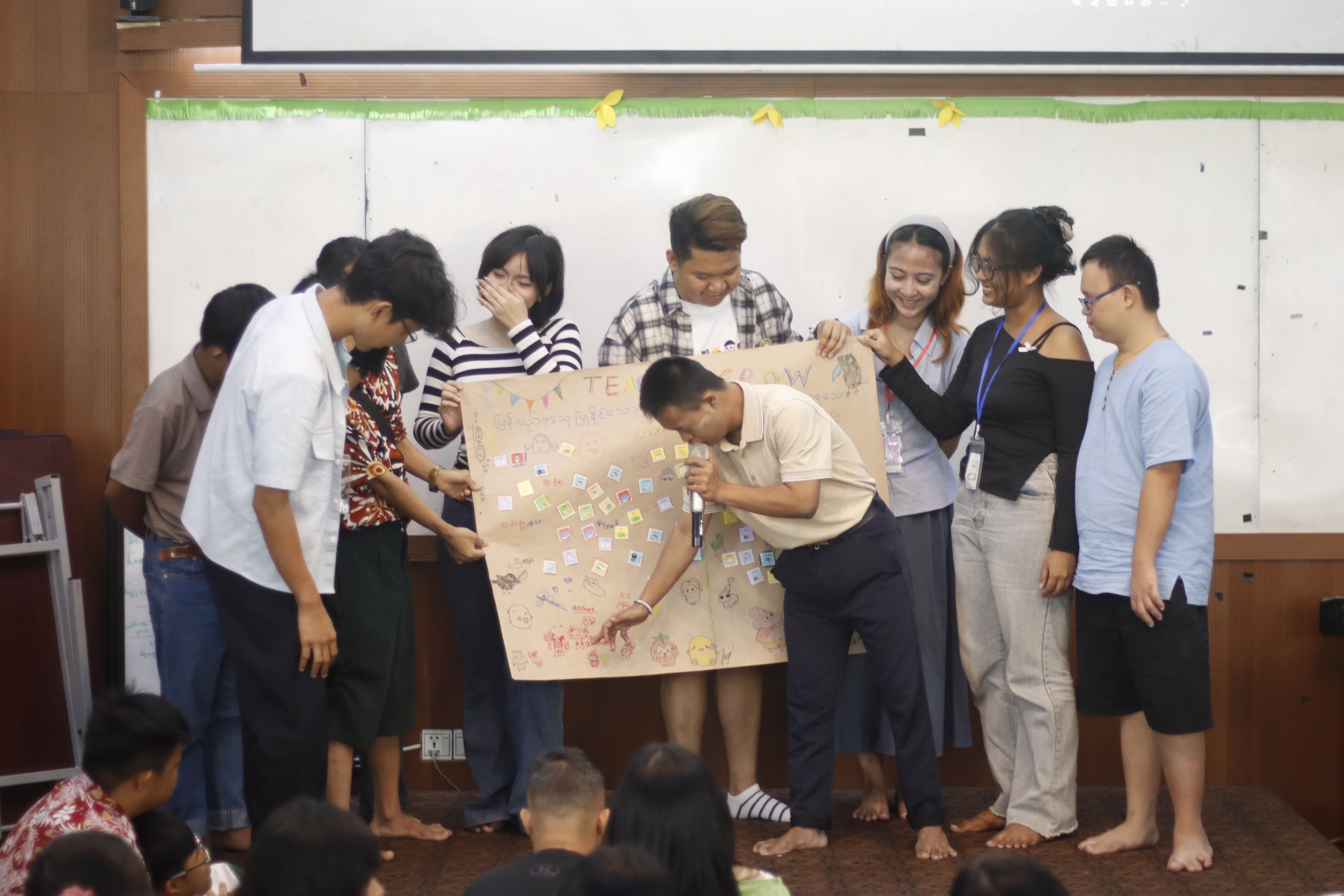 A team presenting their Team Grow poster to the group